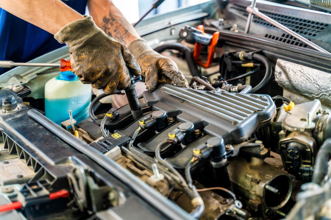 Mobile mechanic repairing an engine on-site